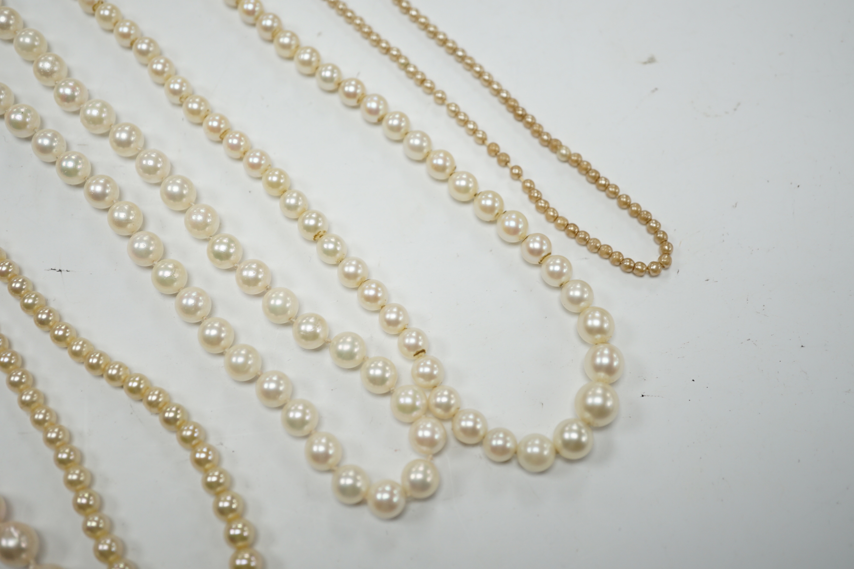 Five assorted single strand cultured pearl necklaces, including four with 9ct clasps, largest 47cm and one other simulated pearl necklace.